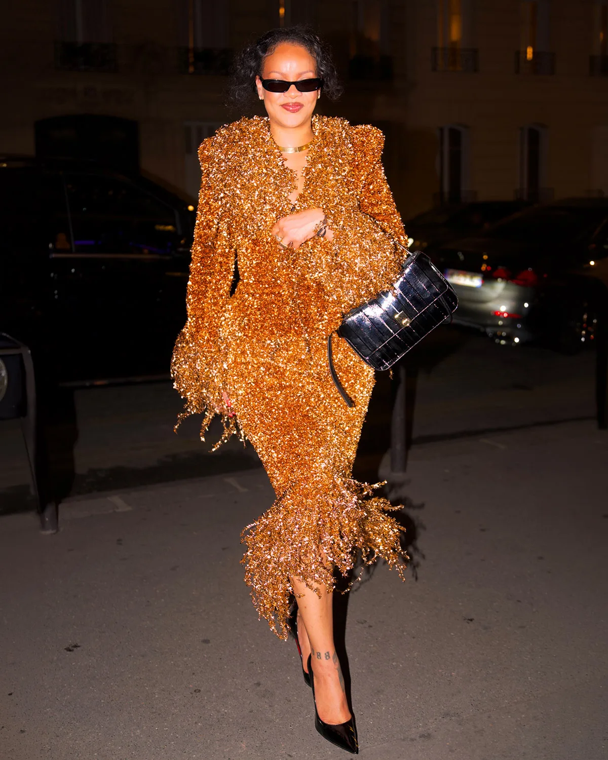 Rihanna wears a Matières Fécales skirt suit with Ferragamo’s Cara bag