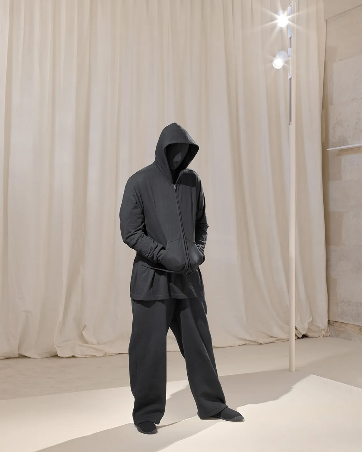 A Demna sculpture by Mark Jenkins, in which the designer wears a zip-up hoodie, baggy sweatpants, t-shirt, and Space shoes from his summer 2022 Red Carpet show for Balenciaga | Source: Balenciaga